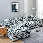 Housse extensible sur canapé d’angle 3 places dans salon moderne. Décoration intérieure